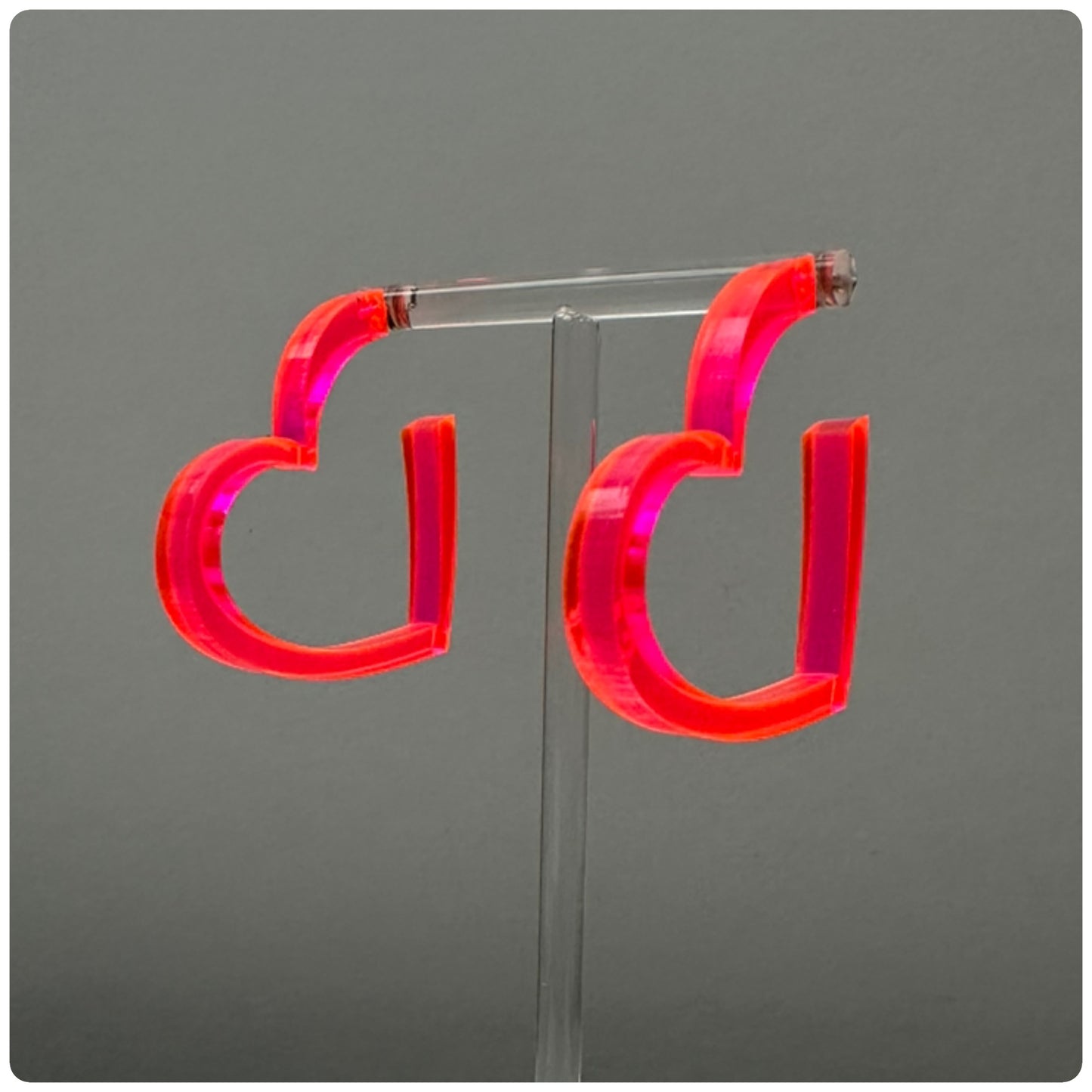 Heart Lucite Hoop Earrings
Stunning lucite hoop earrings. Meticulously handcrafted in the USA, these unique statement pieces feature sterling silver posts and are available in three vibrant colors: ruby red, opaque white, and neon pink. Add a pop of color to your outfit with these gorgeous lucite hoop earrings!