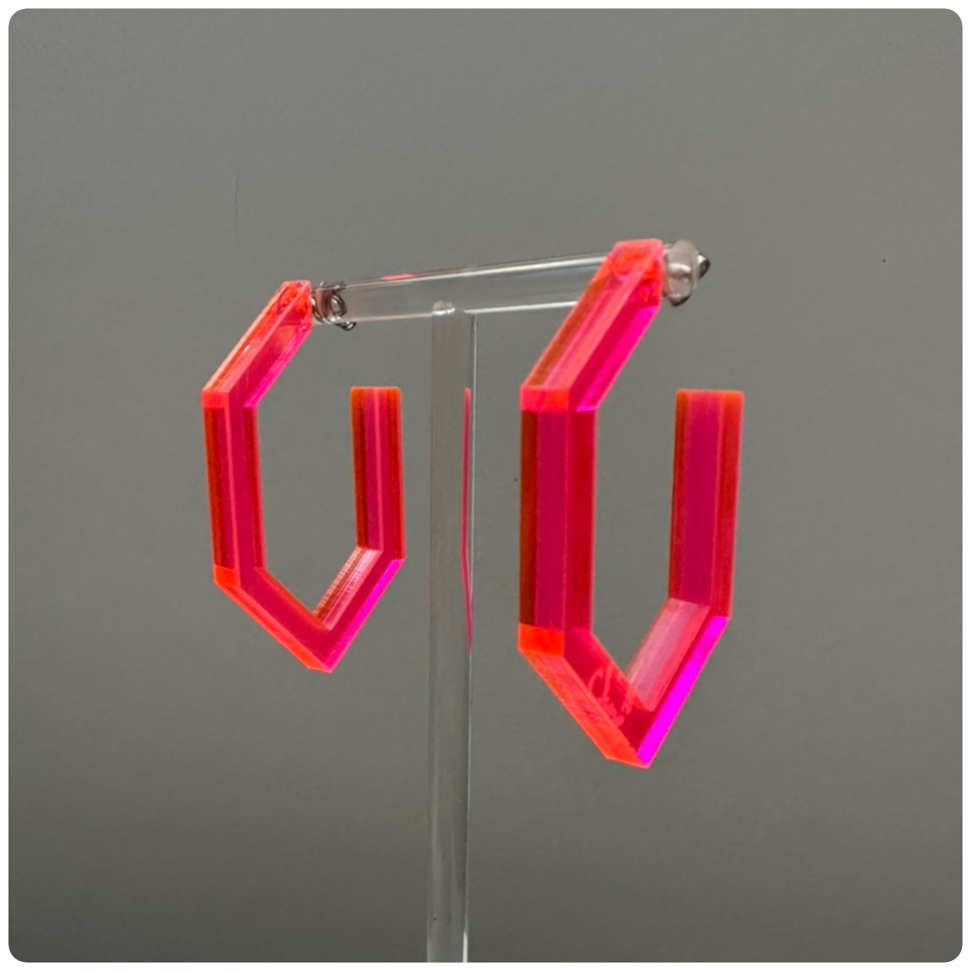 Lucite Modern Hoop Earrings
Handcrafted in the USA | Unique Statement Pieces

Add a bold touch of color and modern elegance with these stunning handcrafted Lucite hoop earrings. Made with sterling silver posts, these hoops are available in three eye-catching colors: neon yellow, neon pink, and smokey grey. A perfect way to elevate your style with a pop of vibrant color!